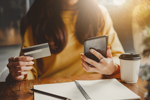 young-beautiful-asian-woman-using-smart-phone-and-credit-card-for-shopping-online-in