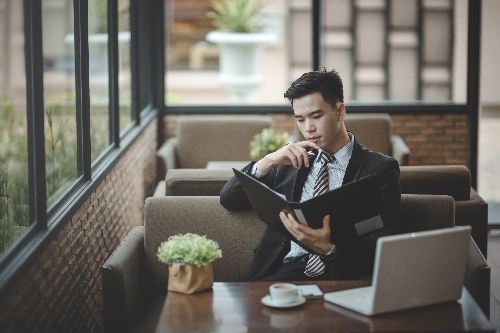 Guy thinking while holding the menu