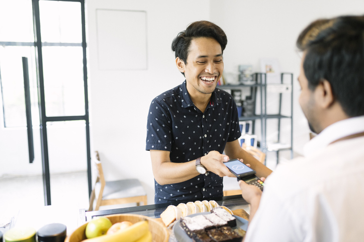 man-making-payment-on-mobile-aia-malaysia