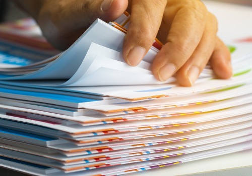 sifting-through-thick-stack-of-documents-aia-malaysia