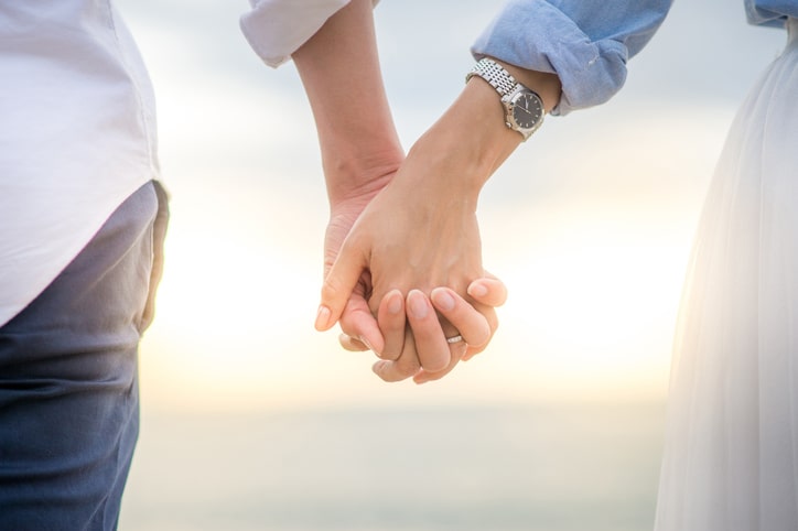 couple-holding-hands-seaside-aia-malaysia