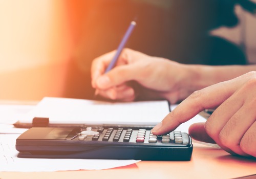 woman-with-calculator-counting-making-notes-aia-malaysia