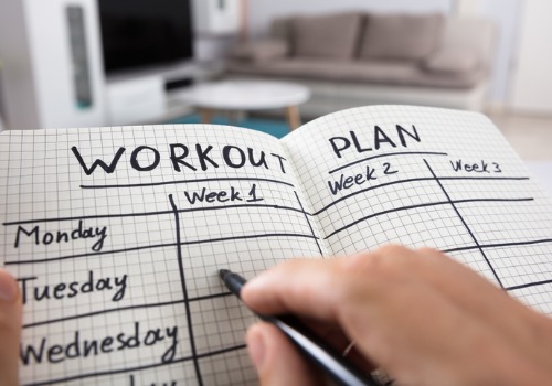 person-writing-workout-plan-in-notebook-aia-malaysia