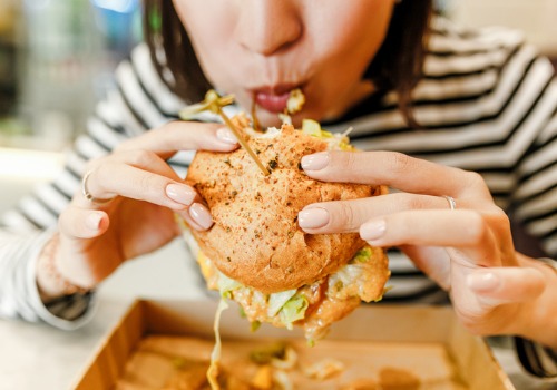 woman-eating-a-hamburger-fastfood-lunc-aia-malaysia