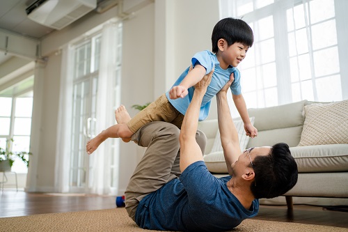 father lifting child