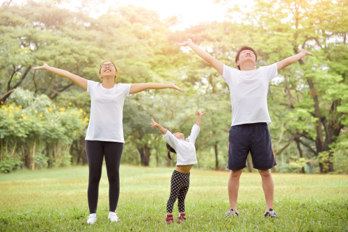 family exercising outdoors sunshine