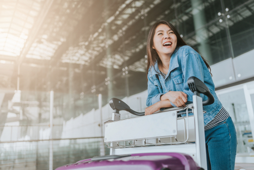 woman in airport with trolley