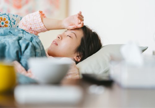 women-lay-sick-arm-bed-aia-malaysia.jpg