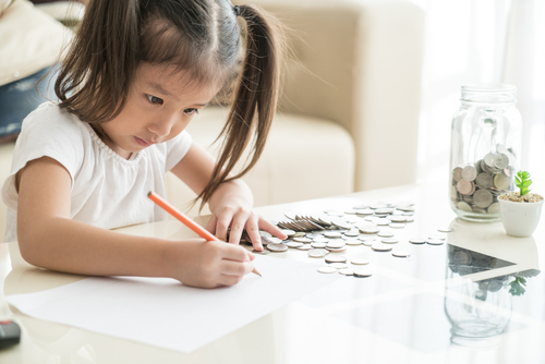 little girl writing on paper