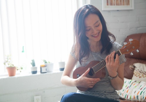 woman-practicing-ukulele-at-home-aia-malaysia