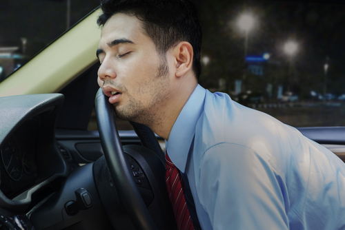 man asleep steering wheel