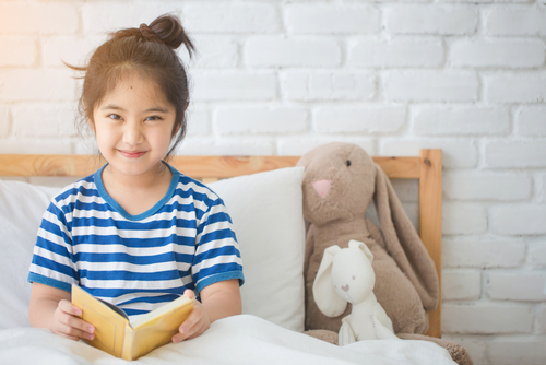 GIRL READING IN BED