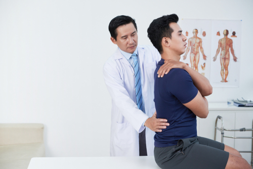 doctor correcting man posture