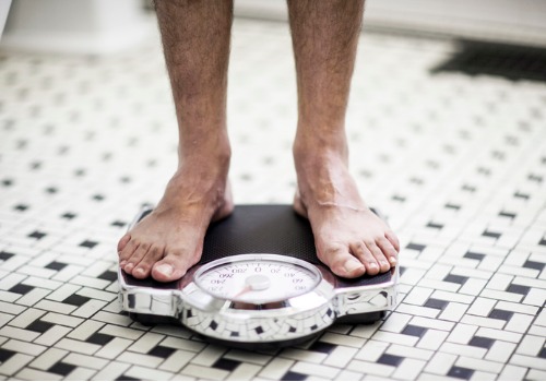 adult-man-on-bathroom-scales-aia-malaysia.jpg