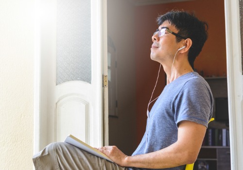 asian-man-meditating-and-writing-gratitude-journal-aia-malaysia
