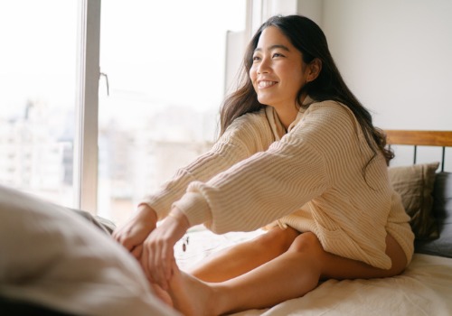 young-woman-stretching-her-legs-for-the-day-on-her-bed-aia-malaysia