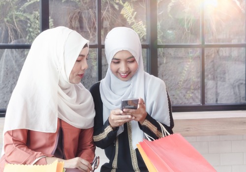 two-muslim-women-carrying-colorful-paper-bags-aia-malaysia