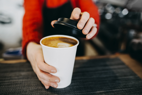 barista covering coffee cup