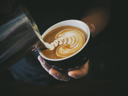pouring milk into latte