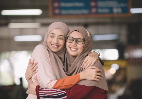 female-friend-hugging-meetup-aia-malaysia