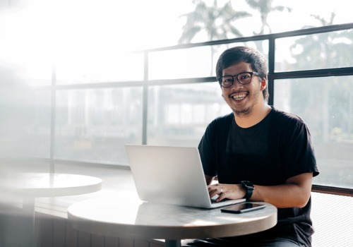 young-man-working-using-laptop-at-cafe-aia-malaysia