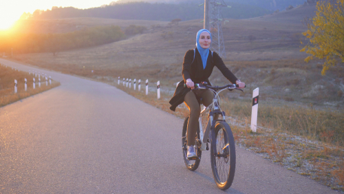 woman cycling open road
