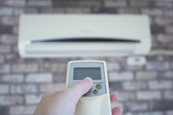 Hand Holding Aircond Remote AIA Malaysia