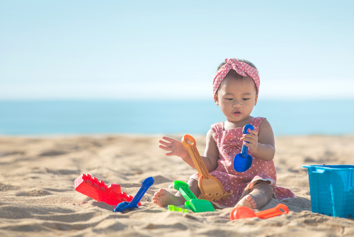 baby playing with sand