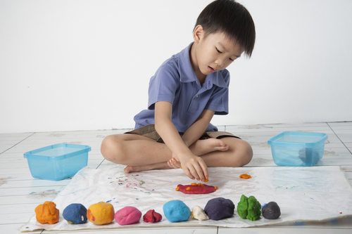 boy play dough on mat