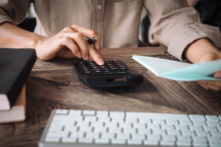 Business woman using calculator