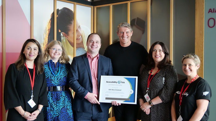 AIA NZ Staff holding the Accessibility Tick award